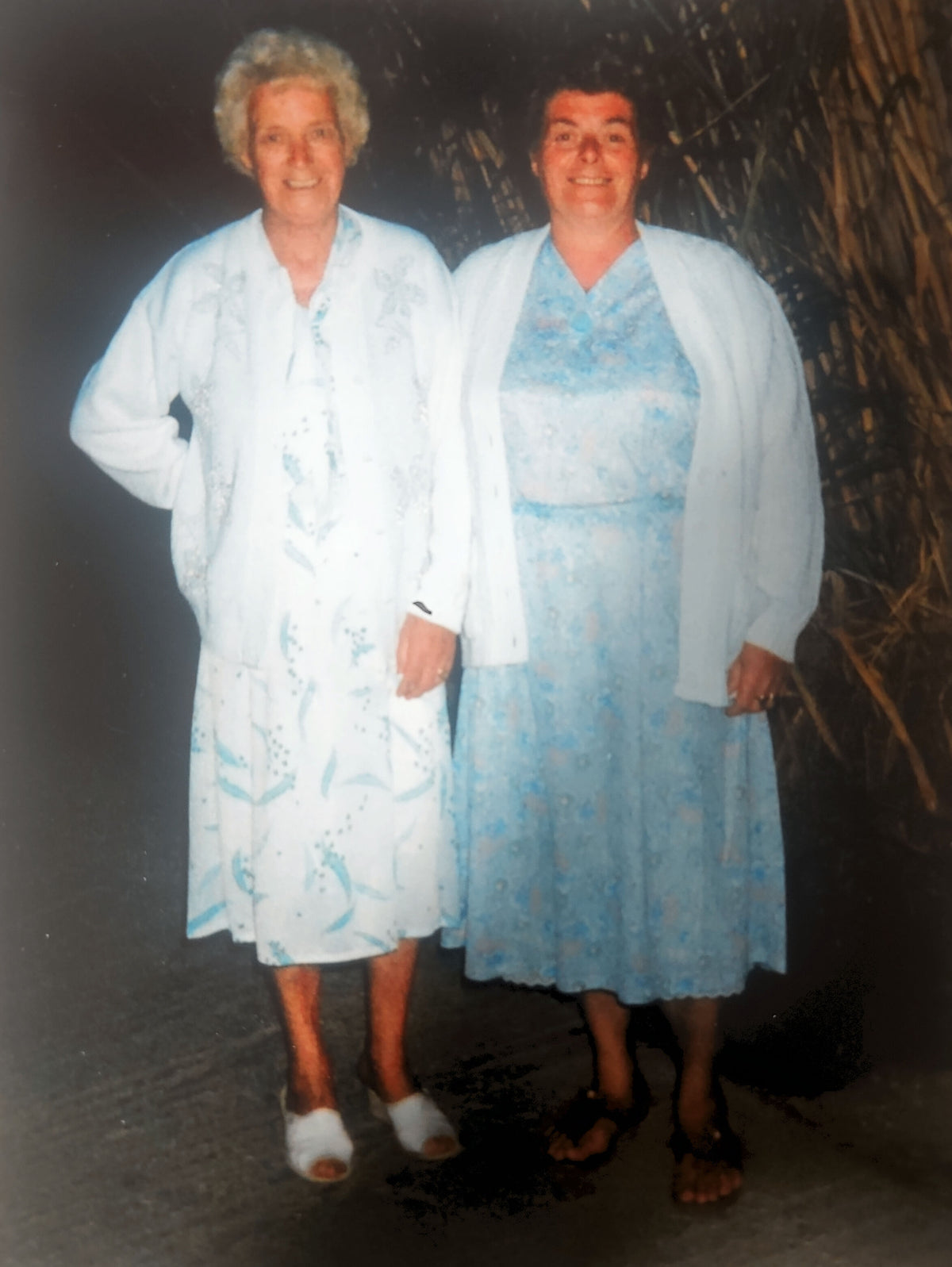 Florence and Amelia standing together in matching pale blue outfits